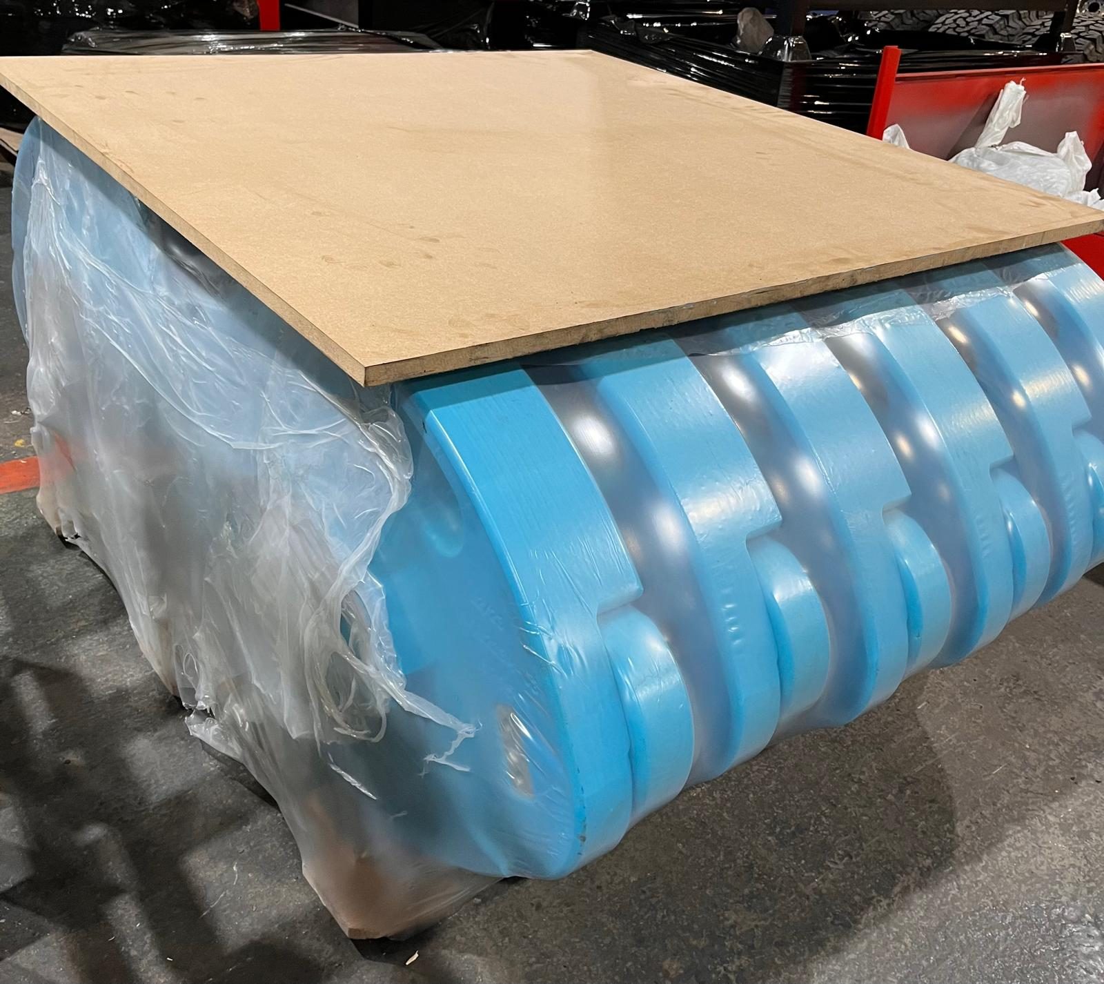 Shrink-wrapped pallet of composite RunFlat segments ready to ship